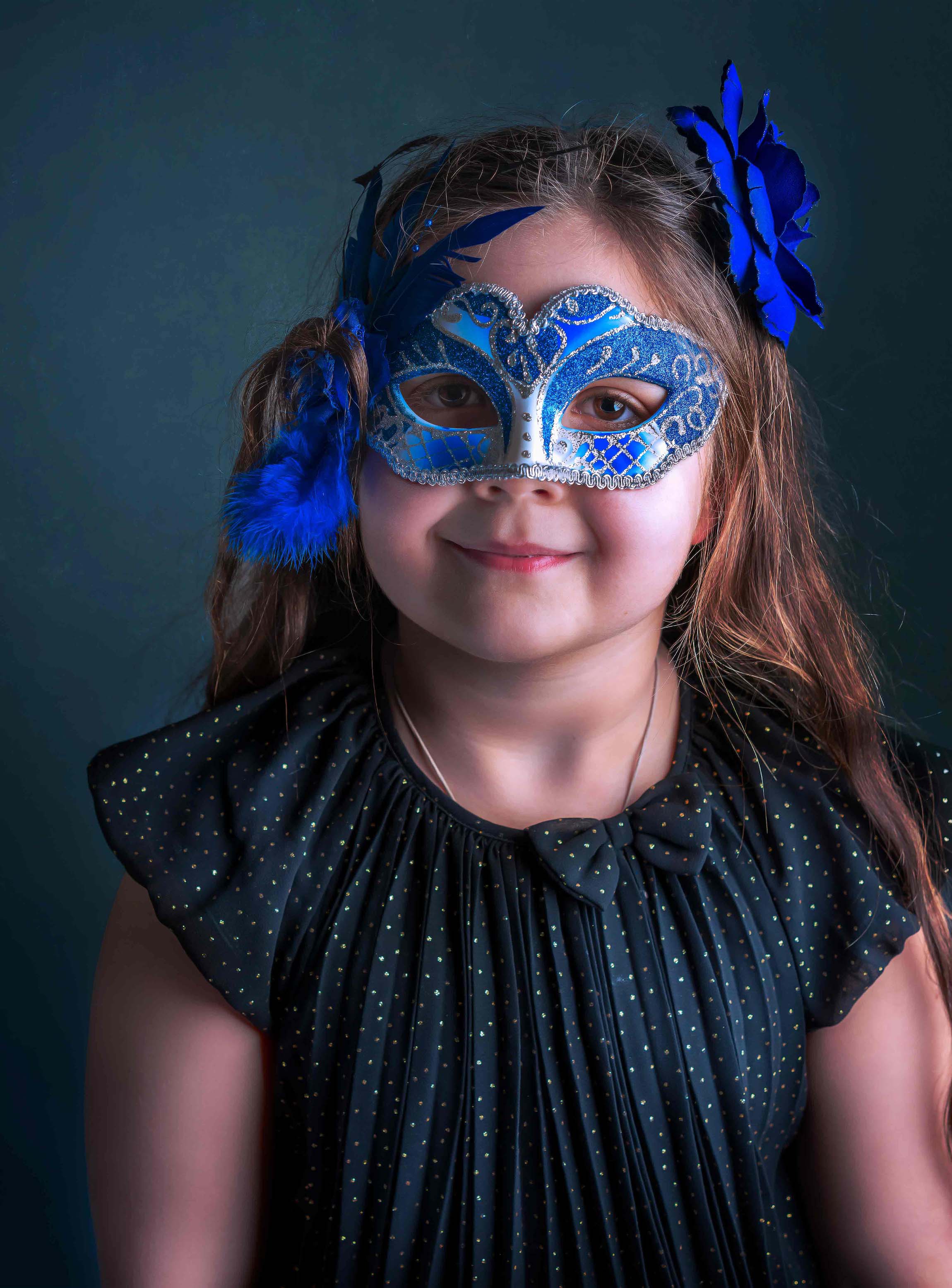 little girl with a venezian mask