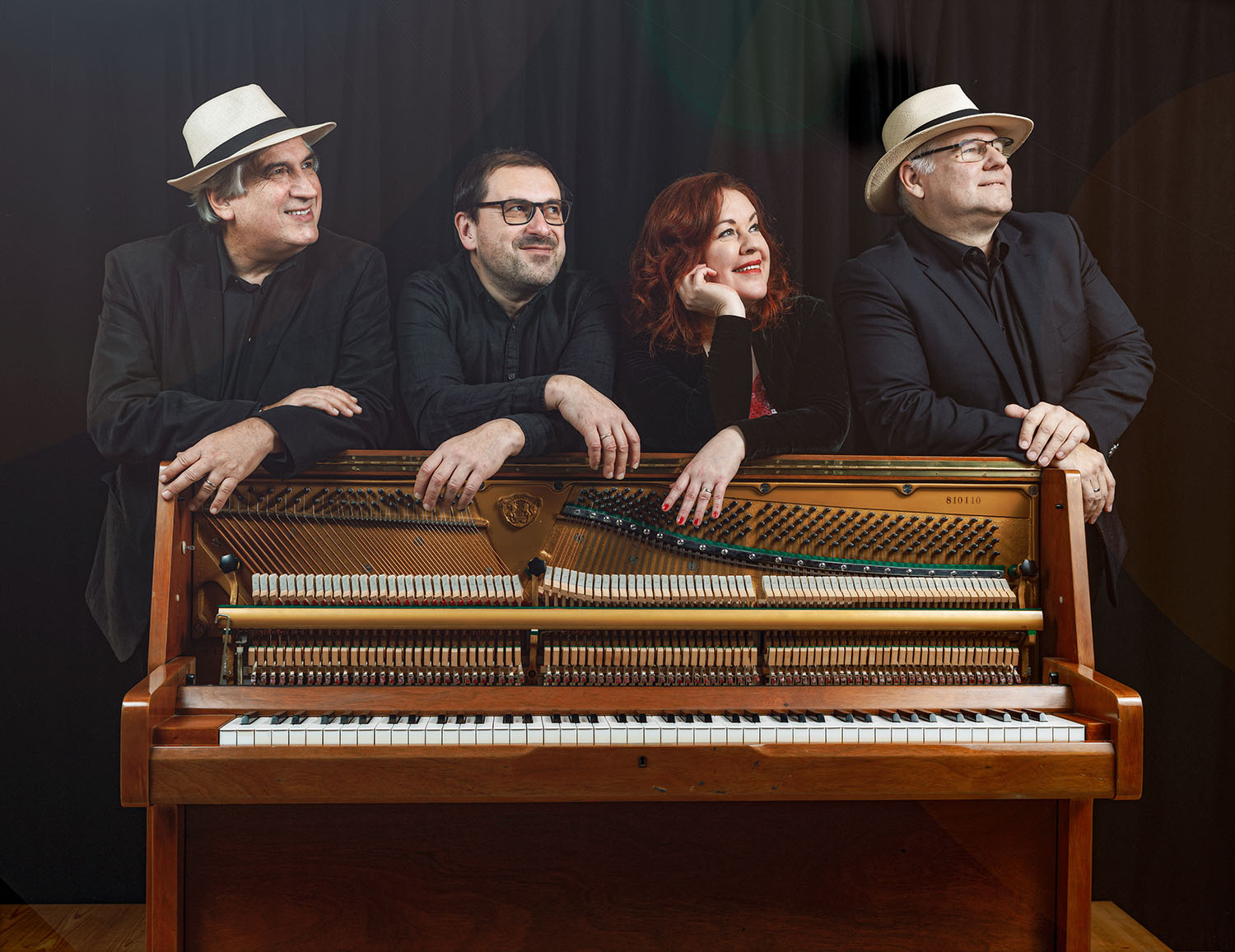 quartet of musicians with a piano